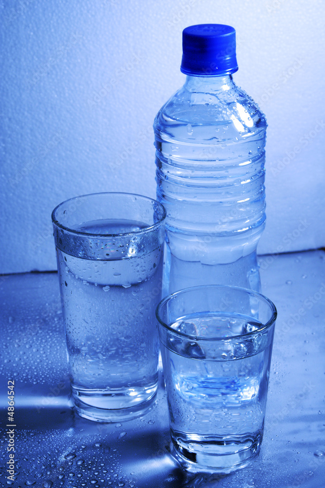 Bottle and glasses of mineral water with droplets Bottle and glasses of mineral water with droplets