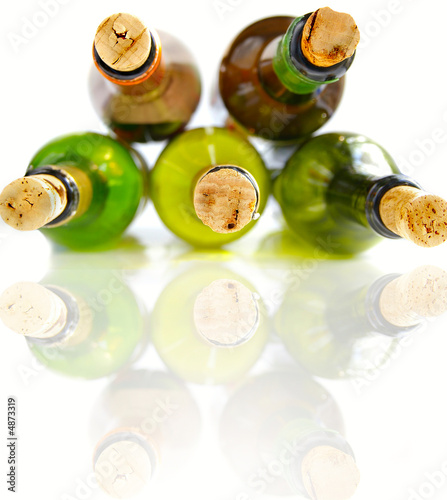 Wine bottles with corks on white