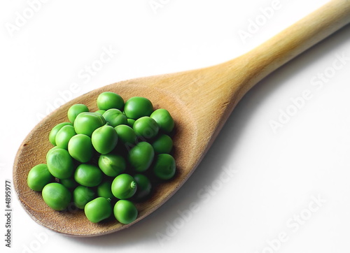 Green peas and wood spoon photo