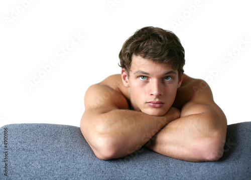 Sexy Muscular Man Leaning on the Sofa