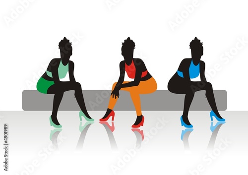 The beautiful girls sits on a sofa