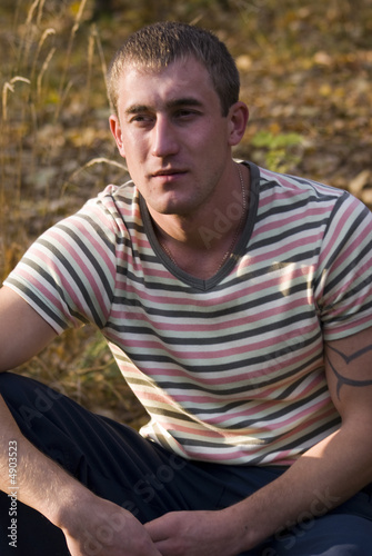 Young man sit in the forest