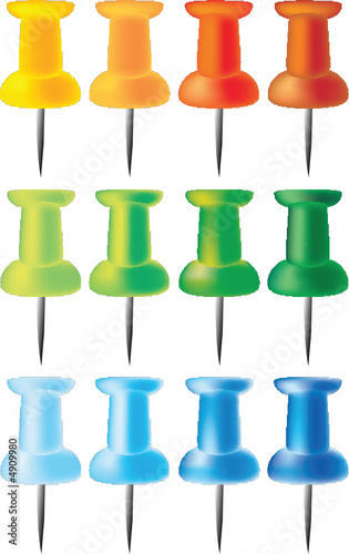 Red green blue colored office pins isolated on white