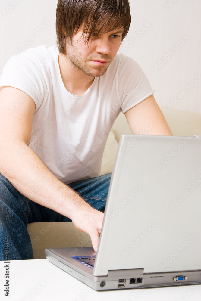 young man home with laptop young man home with laptop