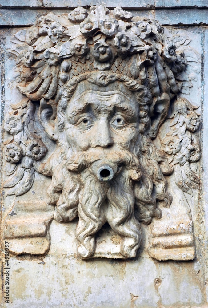 artistic relief of the head on the fountain in Alhambra, Spain