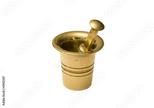 Shiny  brass mortar and pestle isolated on white background