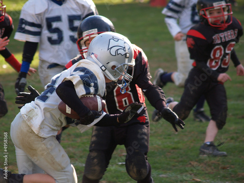 Young football player running with the ball photo