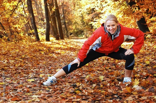 Young, beautiful woman stretching in the park