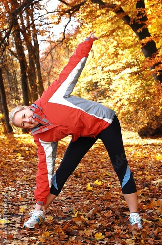 Young, beautiful woman stretching in the park