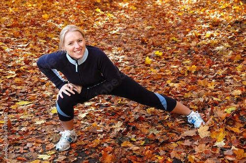 Young, beautiful woman stretching in the park