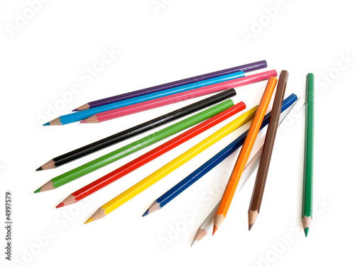 The multi-coloured pencils lay on a white background