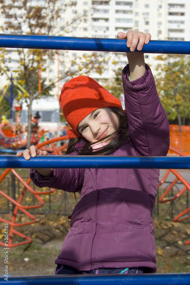 Fototapeta premium child girl hold on ladder