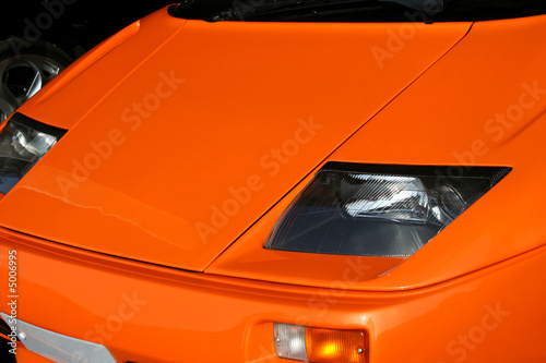 orange supercar headlights © Christopher Nolan