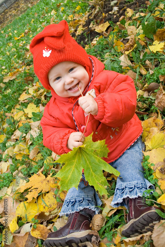 small baby girl sitting on the grass