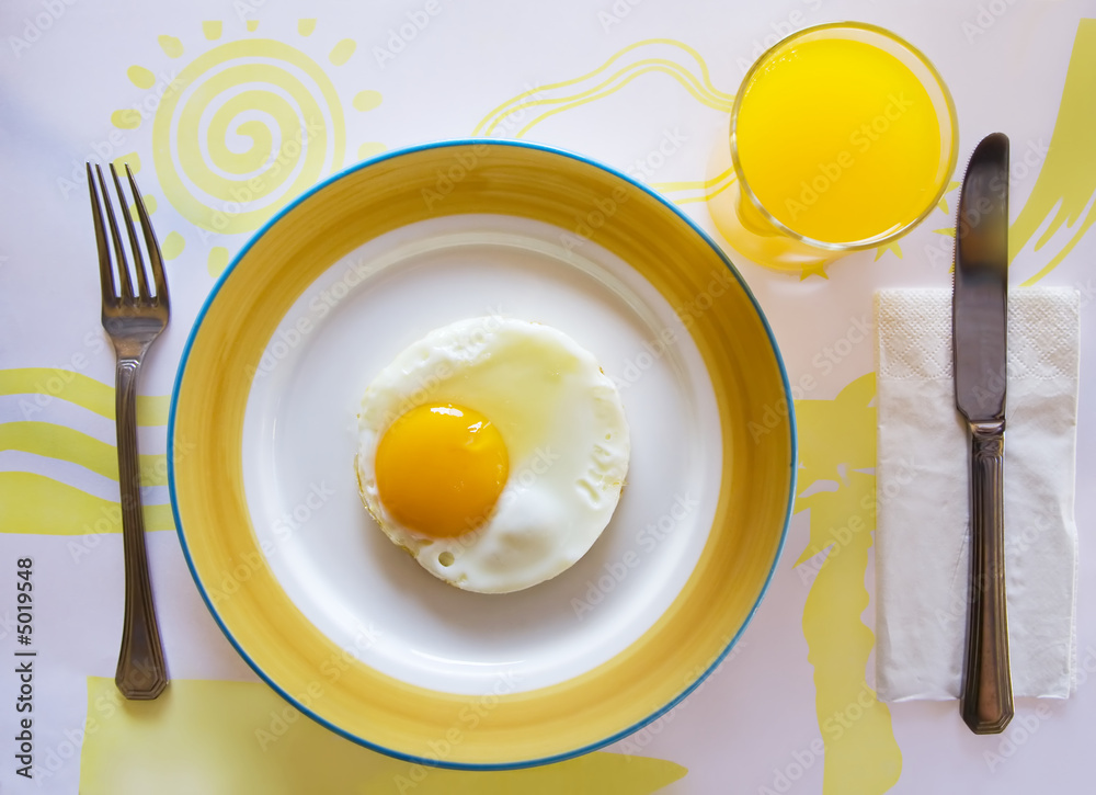 Breakfast with fried egg and orange juice Breakfast with fried egg and orange juice