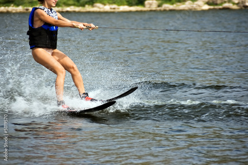 Young woman sliding on the water ski