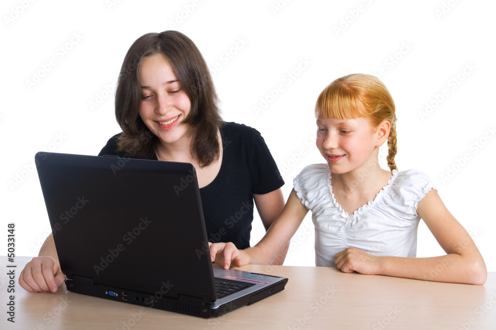 Two girls using a laptop