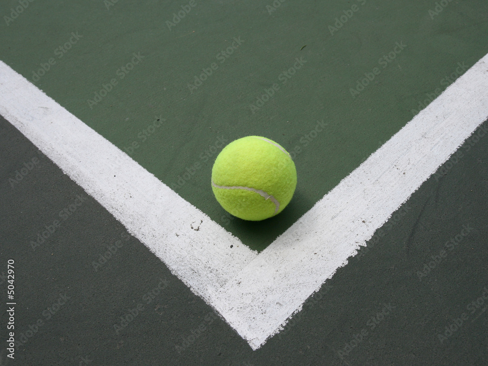 Tennis ball in corner of the field