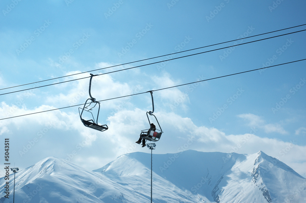 Ski lift chairs on bright winter day