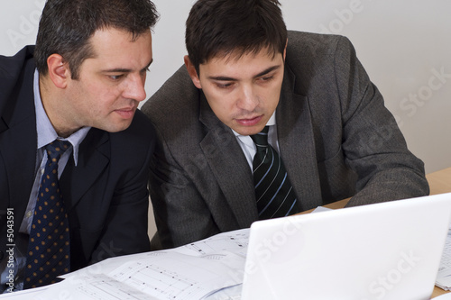 two associates on a laptop