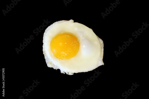 Sunnyside up egg frying isolated on black