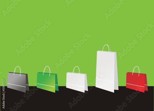 Shopping bags on green background