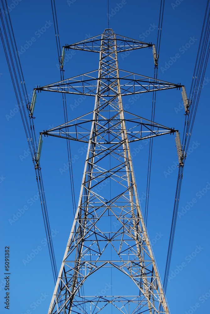 Power lines against blue sky