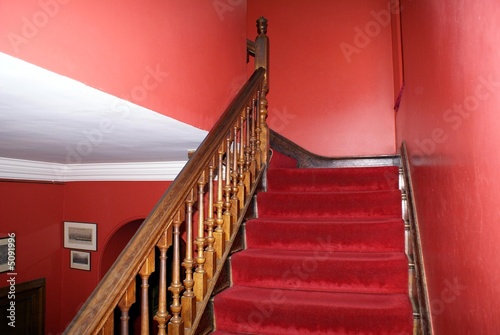 Valokuvatapetti staircase. red staircase with wooden bannister or handrail