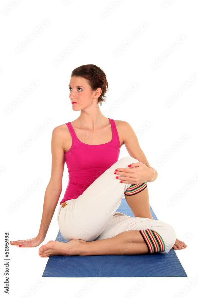 Woman Seated in Yoga Pose Turned to the Side Woman Seated in Yoga Pose Turned to the Side
