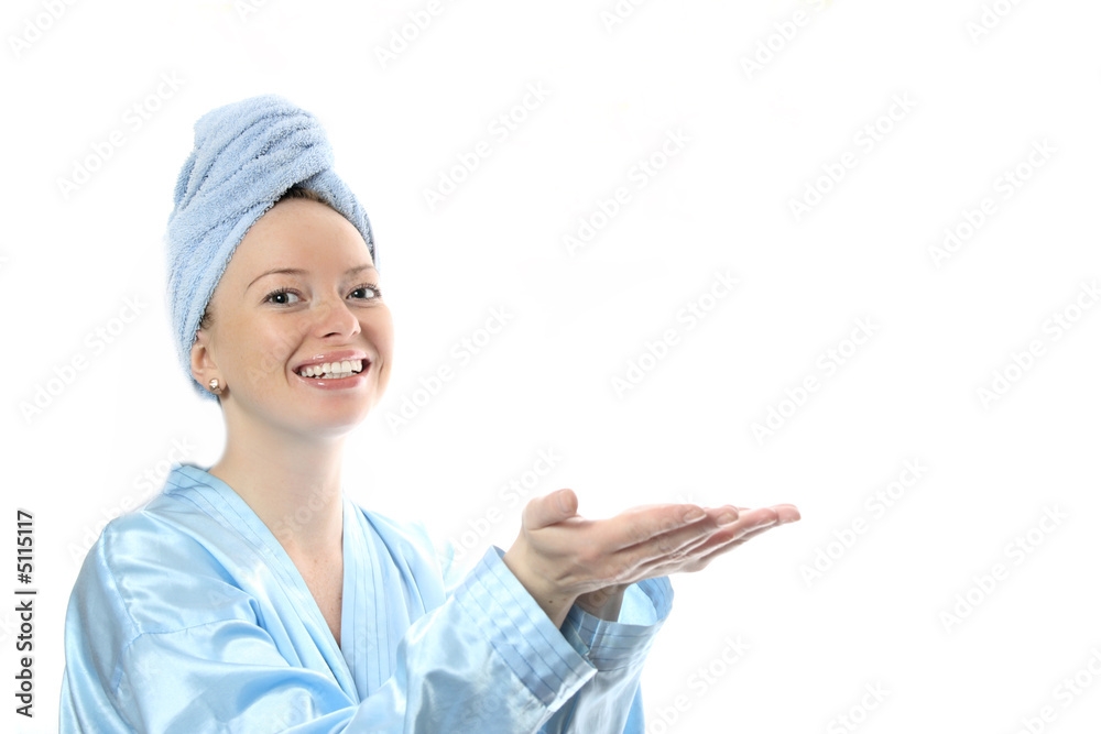 Beautiful girl with towel on her head showing a product on her h Beautiful girl with towel on her head showing a product on her h