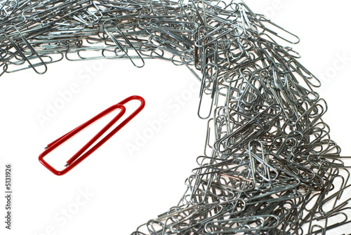 big isolated macro paper clip at many little