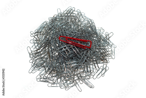 Big isolated macro red paper clip at many little