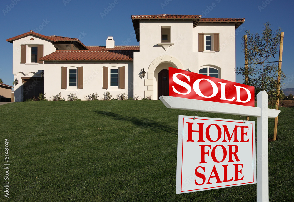 Sold Home For Sale Sign in Front of New House. Sold Home For Sale Sign in Front of New House.