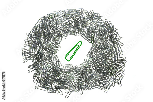 big isolated macro paper clip surrounded by many little