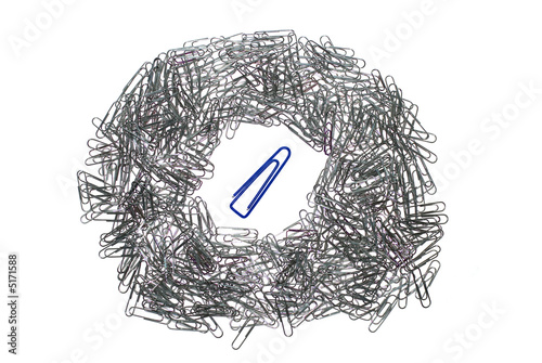 big isolated macro paper clip surrounded by many little
