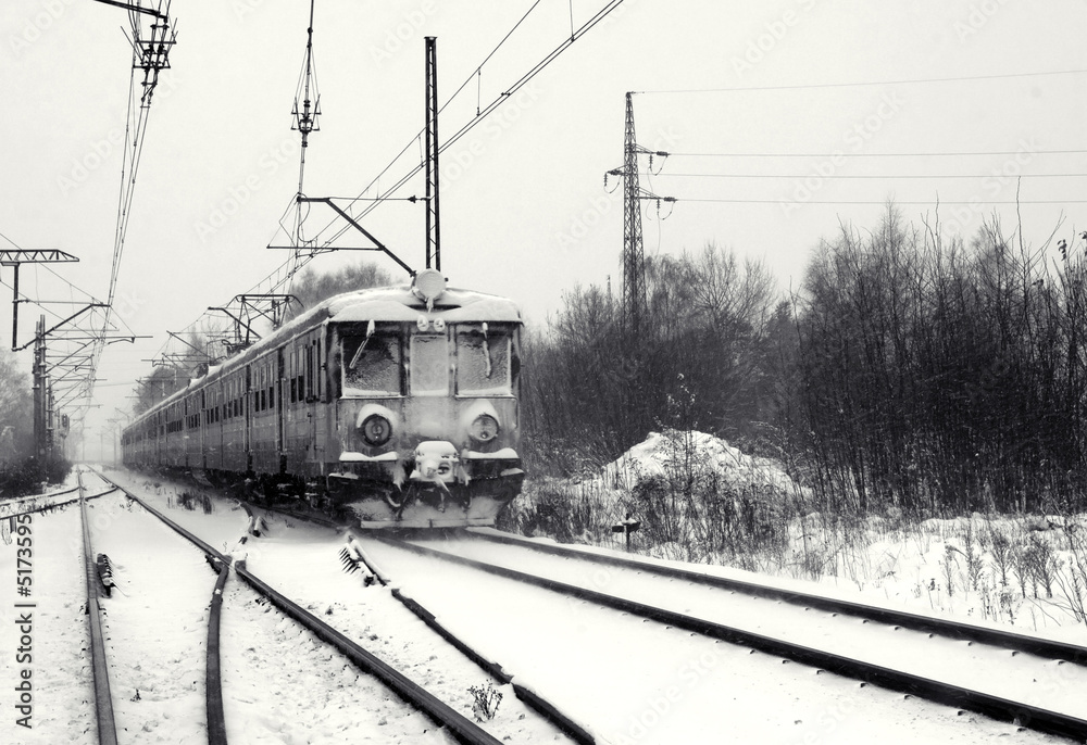 Railway track with train in winter. Black and white