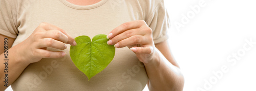 Isolated girl holding a heart shaped green leaf photo