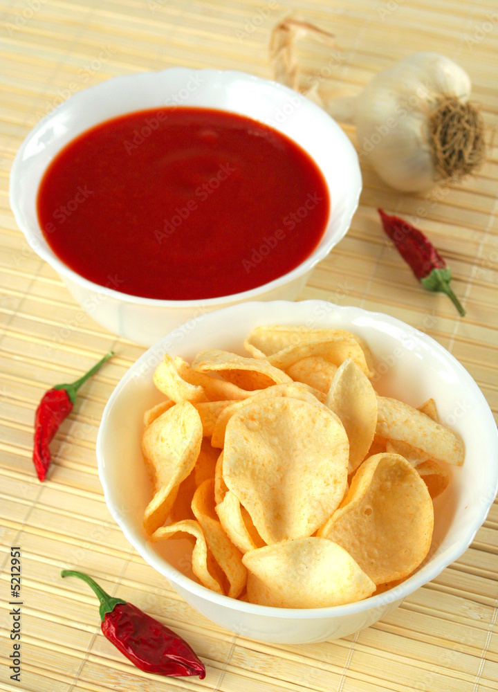 Potato chips with hot salsa dip sauce Potato chips with hot salsa dip sauce