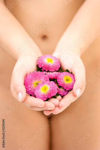 Naked woman holding flowers