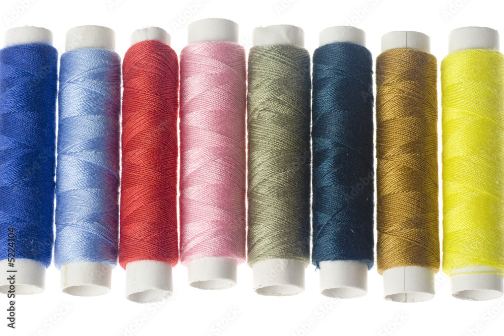 Rows of colorful sewing threads isolated on white background Rows of colorful sewing threads isolated on white background