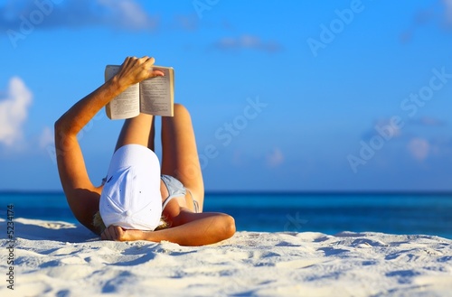 Young women is resting on the coral beach