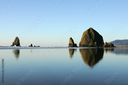 Famous Haystack Rock reflections, Canon Beach, Oregon photo