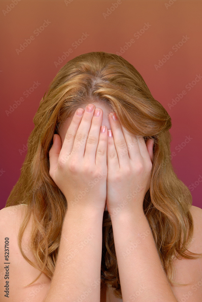 Hands covering face
