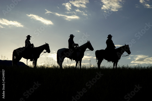Cowboys silhouetted against dawn sky © outdoorsman