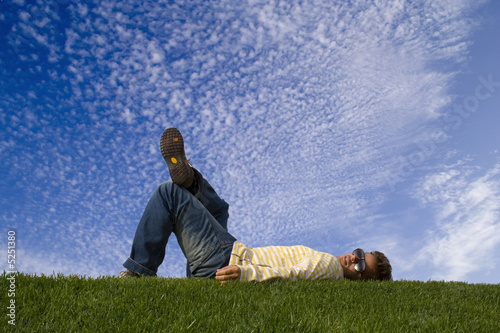 Young man lying down on the grass