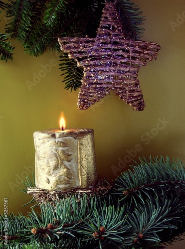 burning candle about Christmas tree photo