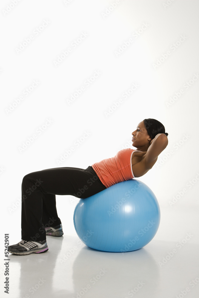 Woman exercising with ball.