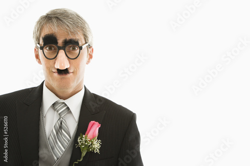 Groom wearing groucho glasses. photo