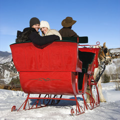 Young couple on sleigh ride.