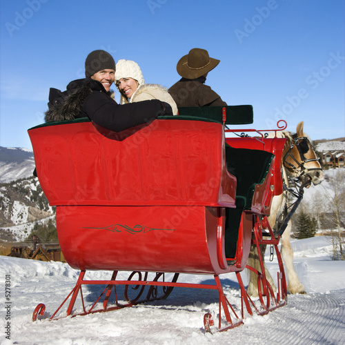 фотографія Young couple on sleigh ride.
